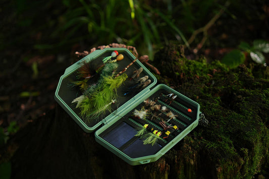 Close up of a Flats Green colored Atollas 1GO Fly Box opened up with various flies inserted into it