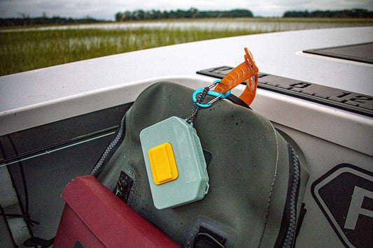 Atollas Micro Fly Box attached to a YETI backpack with a carabiner on a skiff