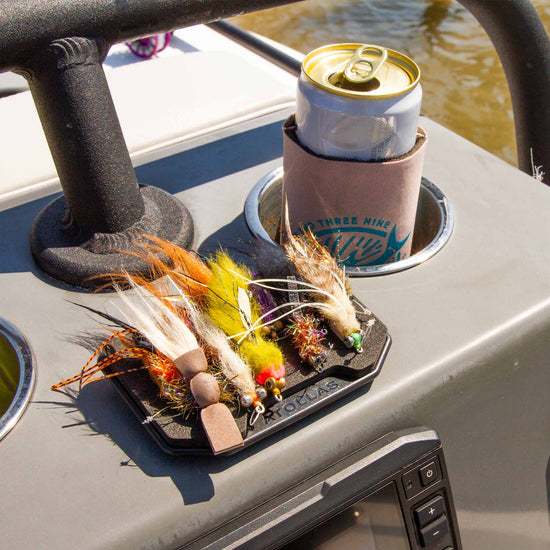 Atollas Fly Caddy XL fly patch clipped into the docking station on the center console of a skiff while boating